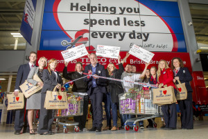 Store manager Kevin Vickery cutting the ribbon with members of Safe Space charity, Harriers Gymnastics, Friends Of Charborough Road School and store colleagues